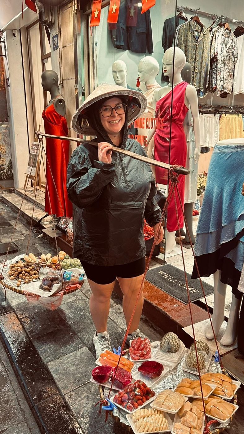 Léa déguisée en marchande ambulante dans une rue du Vietnam